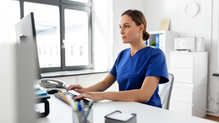 A healthcare provider researching on a computer in an Ambulatory Surgery Center.