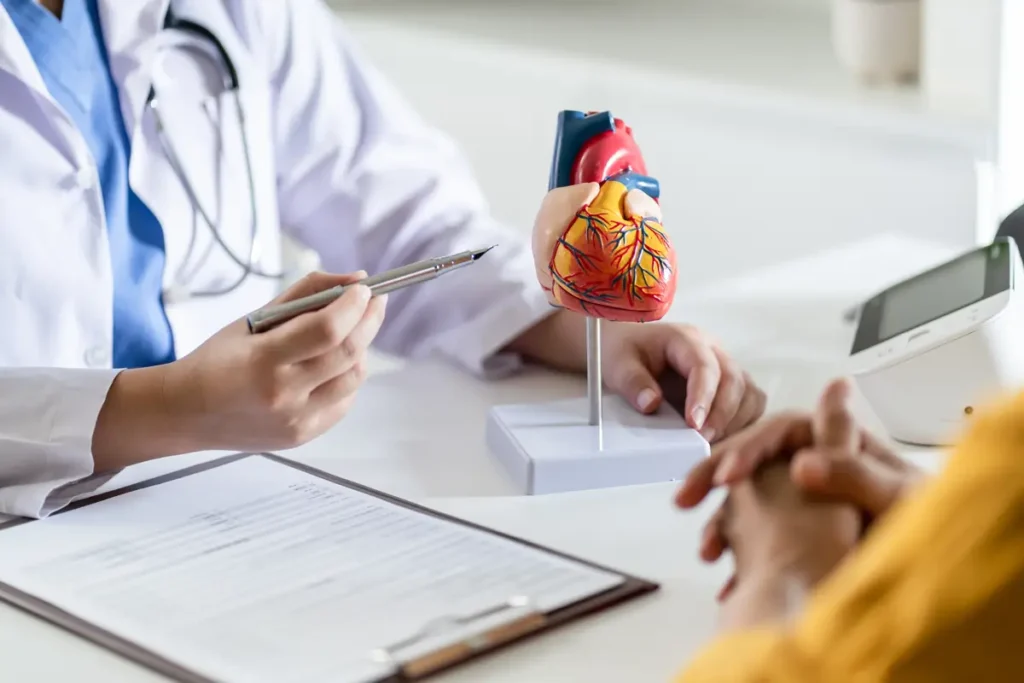 A doctor discusses heart health with a patient in a clinical setting, emphasizing the importance of cardiovascular care.