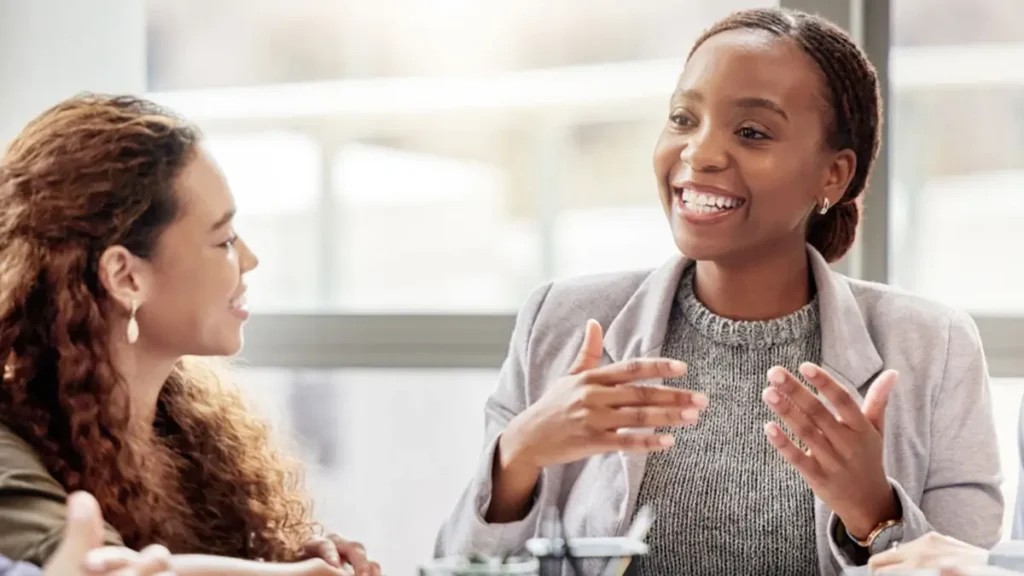 Women speaking at a work meeting